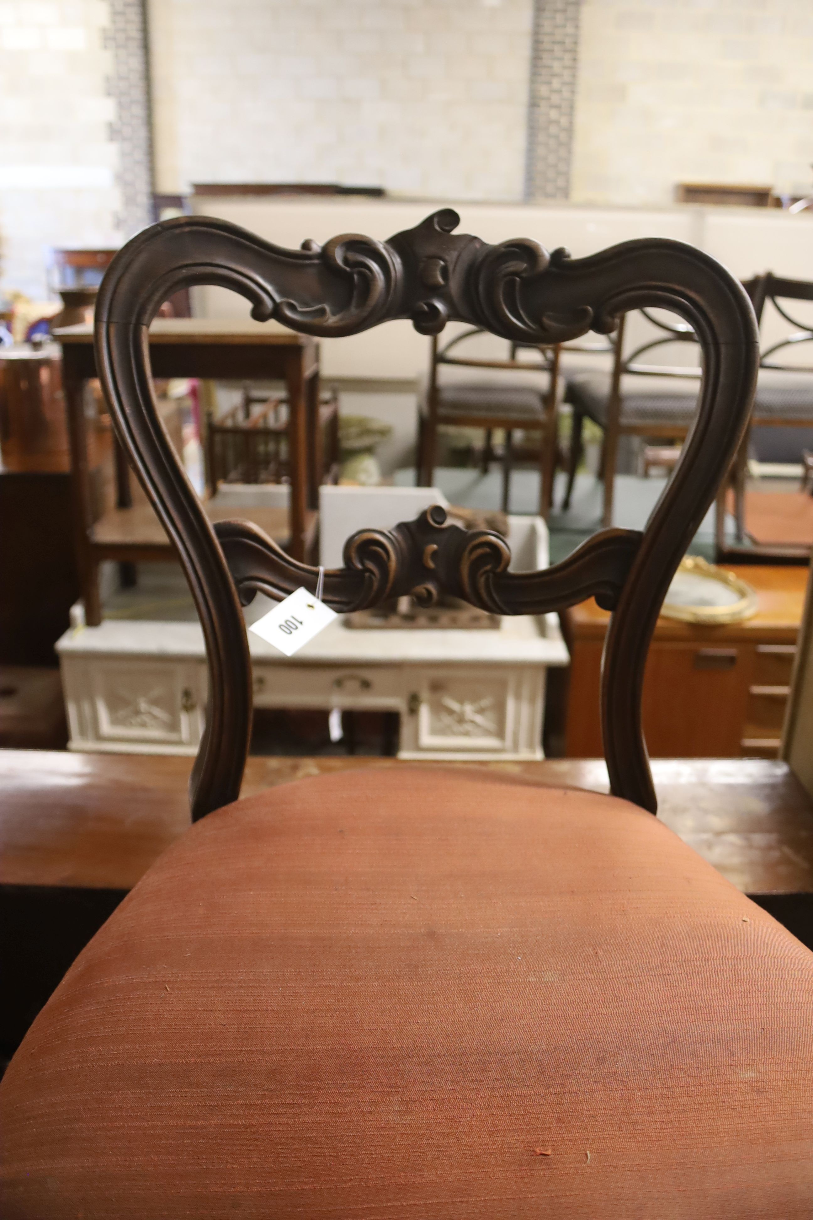 A set of six Victorian carved rosewood balloon back dining chairs